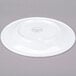 A white porcelain plate shown upside down on a gray background.