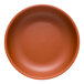 A round, clay-colored satin matte porcelain low bowl.