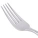 A stainless steel dinner fork with four tines.