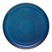 A blue terracotta plate with concentric circular patterns.