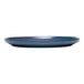 A blue terracotta stack plate with a slightly raised rim.