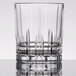 A clear Spiegelau Perfect Serve 12.5 oz. rocks or double old fashioned glass with a faceted design near the base.