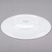 A white porcelain coupe plate shown upside down on a gray background.
