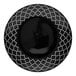 A black porcelain plate with white embossed geometric patterns around the rim.