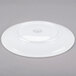A white porcelain coupe plate shown upside down on a gray background.