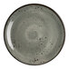 A round, smoke-colored melamine coupe plate with a speckled design.