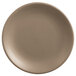 A round, sand-colored matte porcelain coupe plate.