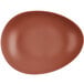 An oval-shaped, clay-colored satin matte porcelain coupe plate.