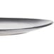 A round, shallow porcelain plate with a smooth, slightly curved edge and a dark gradient finish.