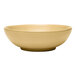 A tan terracotta salad bowl with a simple, round design.