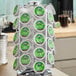 A rotating metal rack holding Green Mountain Coffee Roasters flavored coffee Keurig K-Cup pods in a kitchen setting.