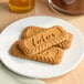 A plate with several rectangular Lotus Biscoff cookies.