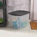 A clear plastic storage tote with a flat gray latching lid.