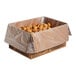 A large cardboard box lined with plastic containing numerous small churro bites.