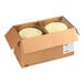 A cardboard box containing two round lemon blueberry cakes.