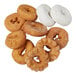 An assortment of cake donuts including plain, powdered sugar, and glazed varieties.