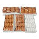 An assortment of packaged cake donuts in various flavors arranged in five boxes.