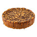 A pre-cut chocolate chip cannoli ricotta cheesecake topped with chocolate and crunchy bits.