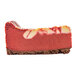 A slice of red velvet ricotta cheesecake with a chocolate crust and marbled topping.