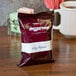 A case of Ellis Mezzaroma City Roast coffee packets on a table.