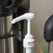 A white plastic syrup pump designed for use with 750 mL bottles.