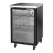 A black counter height glass door back bar refrigerator with shelves and caster wheels.