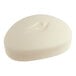 A small, oval-shaped white bar of Dove cream beauty soap.