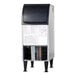 A commercial undercounter flake ice machine with a black top door and a visible lower compartment for components.
