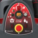 A control panel of a Numatic TBL6055T lithium-ion walk-behind disc floor scrubber with various buttons, switches, and an emergency stop.
