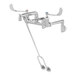 A chrome T&S wall mount mop sink faucet with two wrist action handles and an adjustable arm.