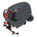 A large industrial floor scrubber with a grey and red design, featuring a control panel, wheels, and a rear squeegee attachment.