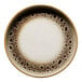 A round porcelain plate with a cream center and a brown spotted rim.
