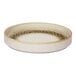 A round porcelain plate with a raised rim, featuring a brown and cream color scheme and a spotted rim design.