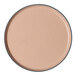 A tan round porcelain plate with a raised rim.
