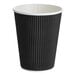 A black 12 oz. double wall ripple paper hot cup.