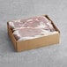 A cardboard box containing two large pieces of frozen, skinned, and deveined beef liver.