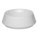 A white round porcelain coupe bowl with a wide rim and smooth finish.