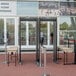 A pair of Garrett Paragon ADA-compliant walk-through metal detectors positioned at the entrance of an arena.