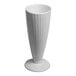 A tall ivory porcelain milkshake mug with a fluted design and a round base.