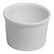 A small, round, ivory porcelain ramekin.