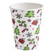 A 12 oz. paper hot cup with a Christmas-themed print featuring trees, presents, holly, candy canes, and snowflakes.