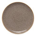 A round, brown, rimless porcelain coupe plate with a speckled pattern.