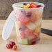 A Pactiv translucent plastic deli container filled with fruit.