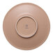 A round brown porcelain coupe saucer with a raised center and the brand name Ariane on the bottom.