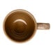 A brown porcelain espresso cup with a handle, viewed from above.