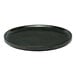 A black round porcelain plate with a raised rim.