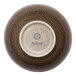 A brown round porcelain coupe bowl with a speckled pattern, shown upside down to display the Ariane brand on the bottom.