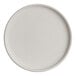 A round, light-colored porcelain stack plate with a slightly raised rim.