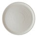 A round, off-white porcelain plate with a subtle textured pattern.