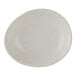 A small, irregularly shaped white porcelain oil dish with a speckled finish.